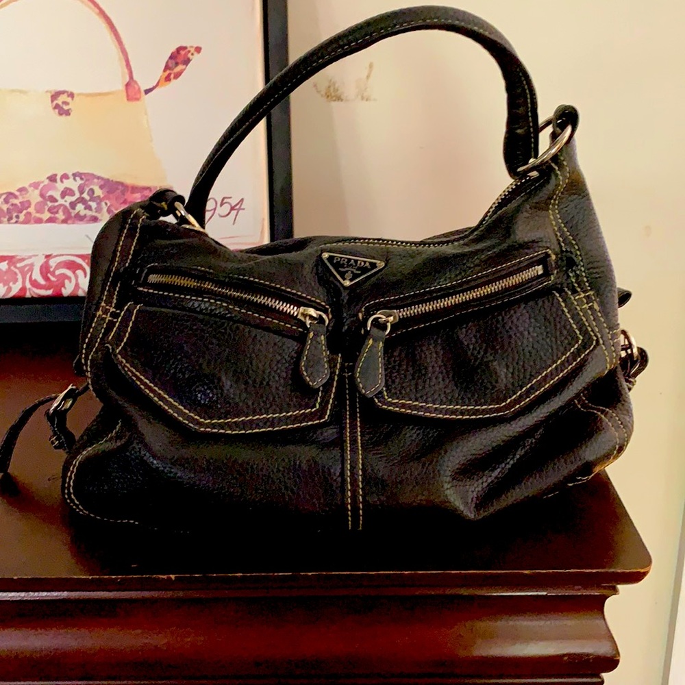 A black leather Prada handbag.